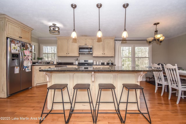 241 Warrior Rd, Alexander City, AL 35010 - kitchen with a breakfast bar, ornamental molding, light brown cabinets, stainless steel appliances, and light wood-style floors