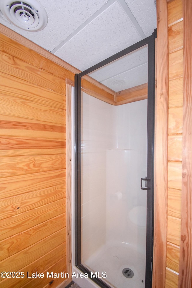 241 Warrior Rd, Alexander City, AL 35010 - bathroom featuring wooden walls, visible vents, and a stall shower