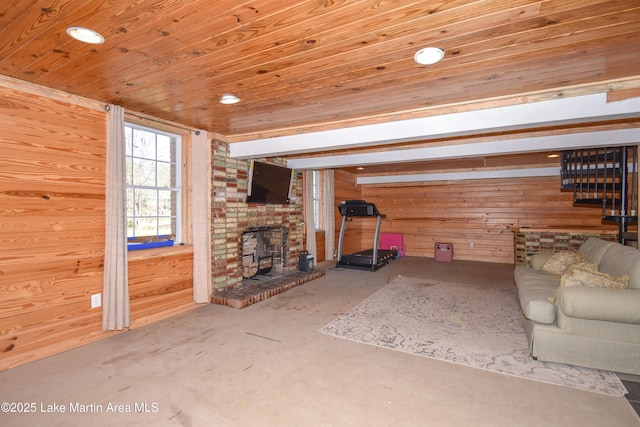 241 Warrior Rd, Alexander City, AL 35010 - unfurnished living room with wooden ceiling, a brick fireplace, and wood walls