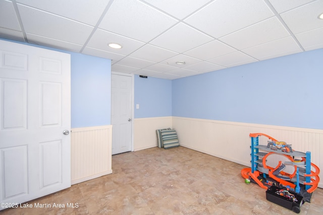 241 Warrior Rd, Alexander City, AL 35010 - recreation room with a drop ceiling and wainscoting