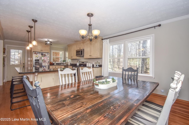 241 Warrior Rd, Alexander City, AL 35010 - dining space with a chandelier, wood finished floors, and ornamental molding