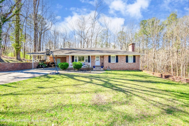 241 Warrior Rd, Alexander City, AL 35010 - ranch-style house featuring a front lawn, a carport, concrete driveway, and a chimney