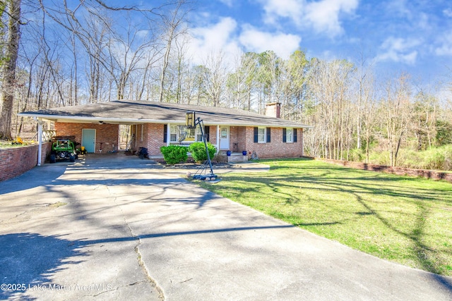 241 Warrior Rd, Alexander City, AL 35010 - ranch-style home with brick siding, concrete driveway, a front yard, a chimney, and a carport