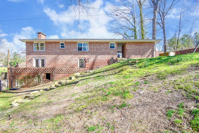 241 Warrior Rd, Alexander City, AL 35010 - rear view of property with brick siding and a chimney