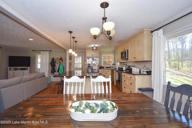 241 Warrior Rd, Alexander City, AL 35010 - dining space with a wealth of natural light, a notable chandelier, wood finished floors, and ornamental molding