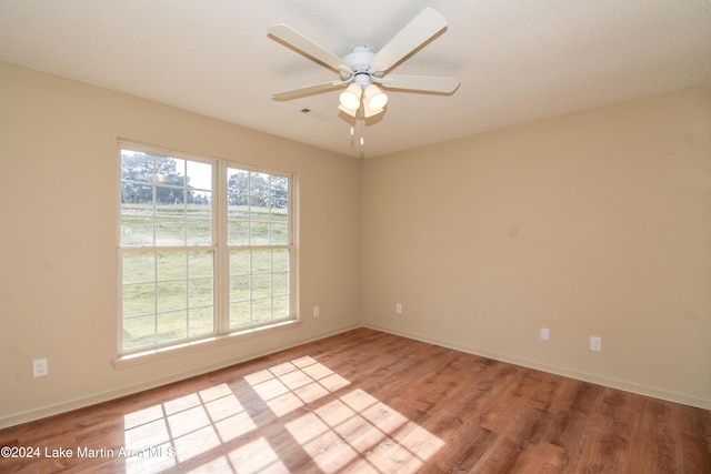 empty room with light hardwood / wood-style floors and ceiling fan