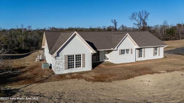 rear view of property featuring central AC