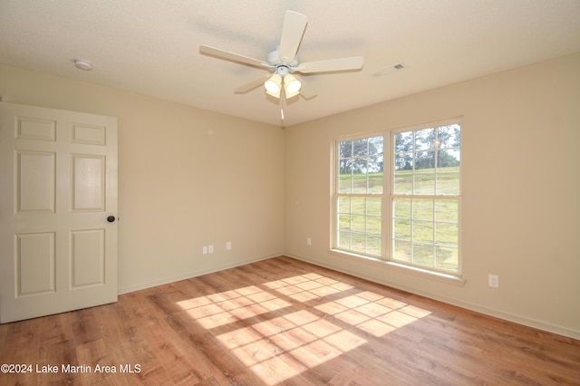 spare room featuring light wood-type flooring and ceiling fan