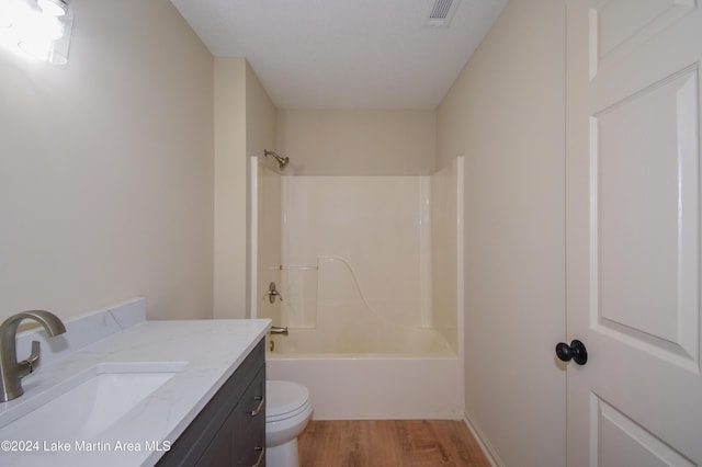 full bathroom with vanity, toilet, bathtub / shower combination, and hardwood / wood-style floors