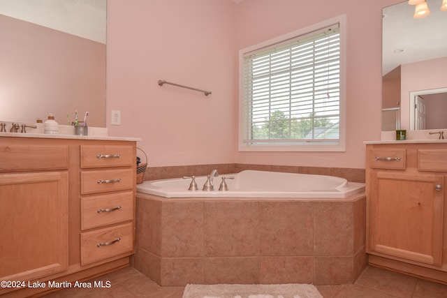 bathroom with vanity, tiled bath, and tile patterned floors