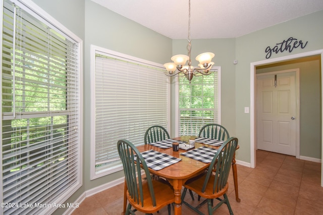 dining space featuring a healthy amount of sunlight, tile patterned floors, and a notable chandelier