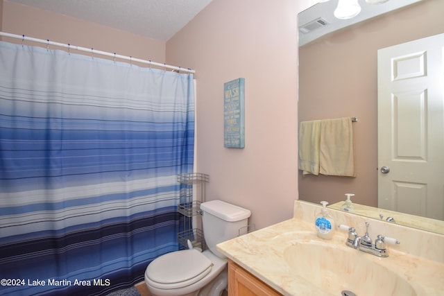 bathroom with vanity, a textured ceiling, toilet, and walk in shower