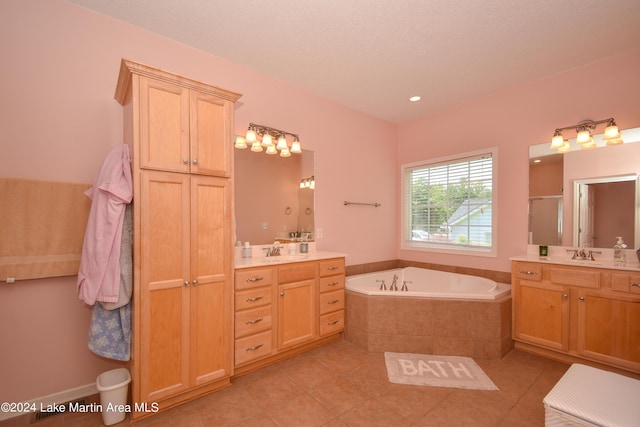 bathroom with plus walk in shower, vanity, and tile patterned floors