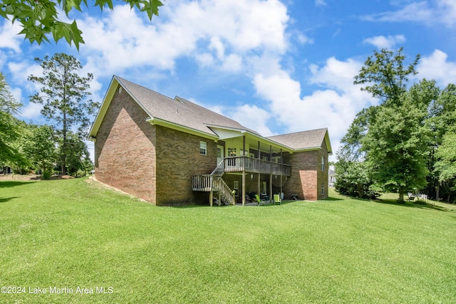 back of property featuring a lawn