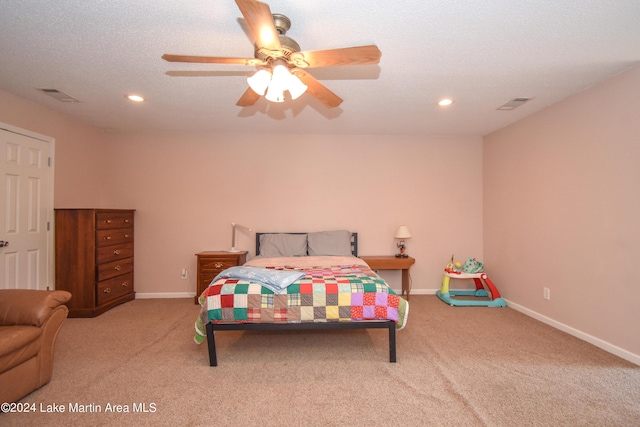 carpeted bedroom with a textured ceiling and ceiling fan