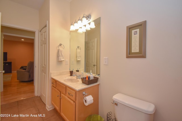 bathroom featuring tile patterned floors, vanity, and toilet