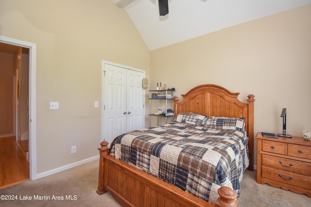 carpeted bedroom featuring ceiling fan, lofted ceiling, and a closet