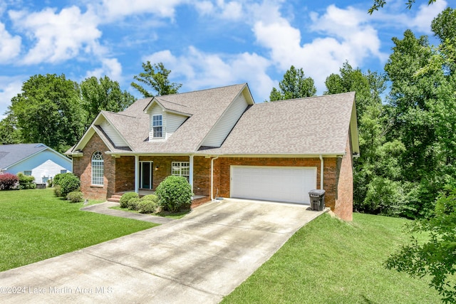 view of front of property featuring a garage and a front lawn