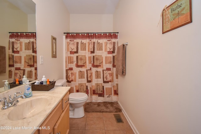 bathroom featuring toilet, vanity, tile patterned floors, and walk in shower