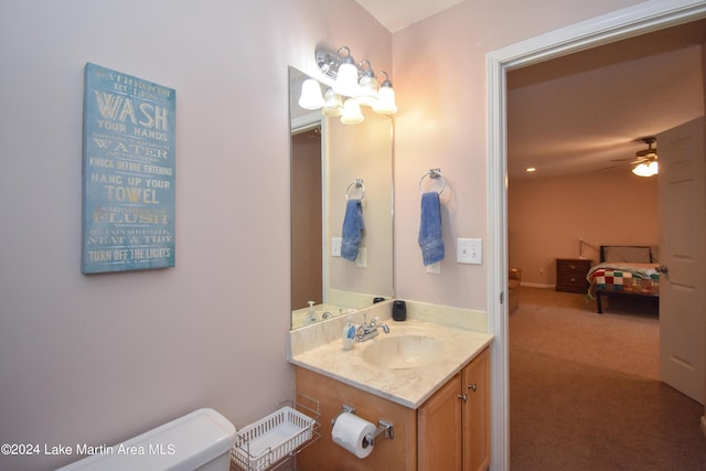 bathroom featuring vanity, ceiling fan, and toilet