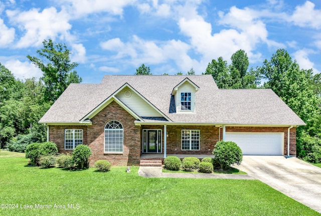 view of front facade featuring covered porch, a garage, and a front lawn