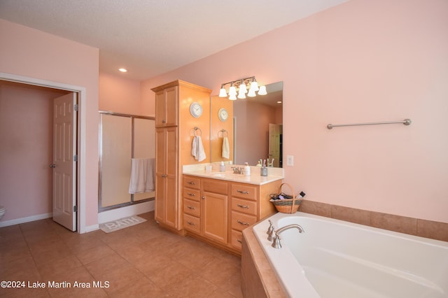 bathroom with tile patterned floors, vanity, and independent shower and bath