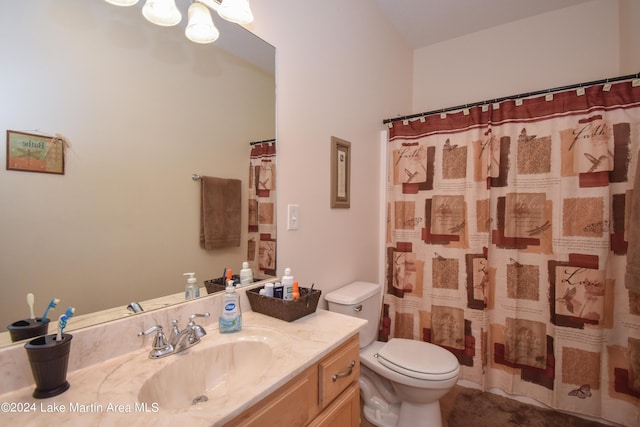 bathroom with curtained shower, vanity, and toilet