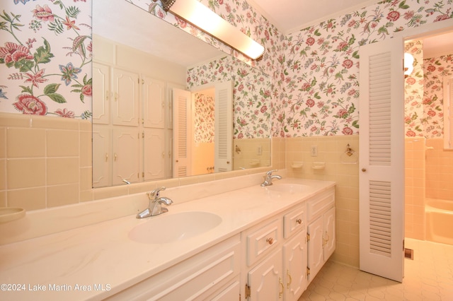 bathroom with tile patterned flooring, vanity, and tile walls