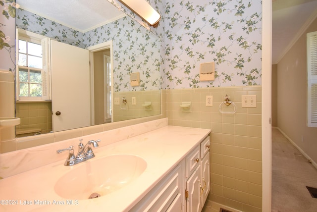 bathroom featuring vanity, tile walls, and crown molding