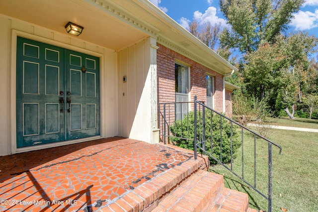 property entrance with a yard