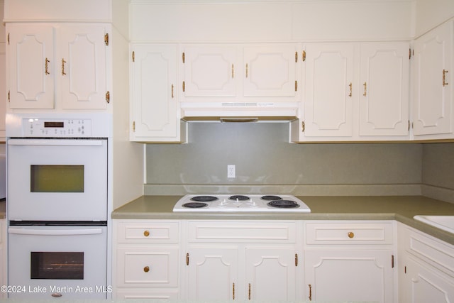 kitchen with white appliances and white cabinetry