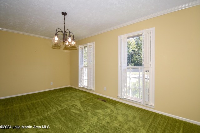 carpeted empty room with a textured ceiling, crown molding, and an inviting chandelier