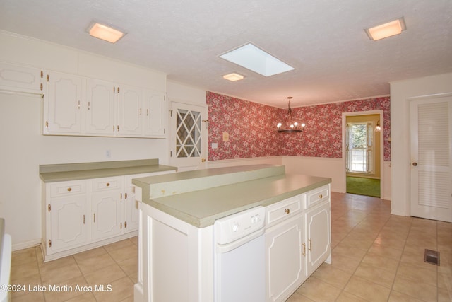 kitchen with white cabinets, pendant lighting, a textured ceiling, and a skylight