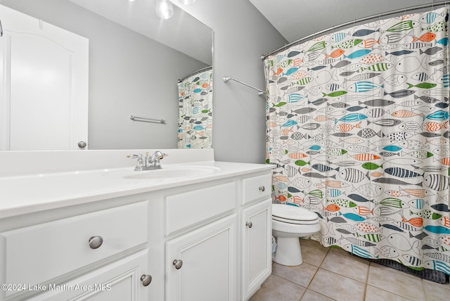 bathroom featuring tile patterned flooring, vanity, and toilet