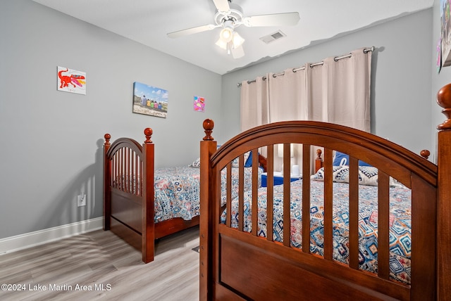 bedroom with light wood-type flooring and ceiling fan