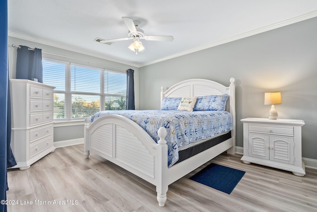 bedroom with light wood-type flooring, ceiling fan, and ornamental molding