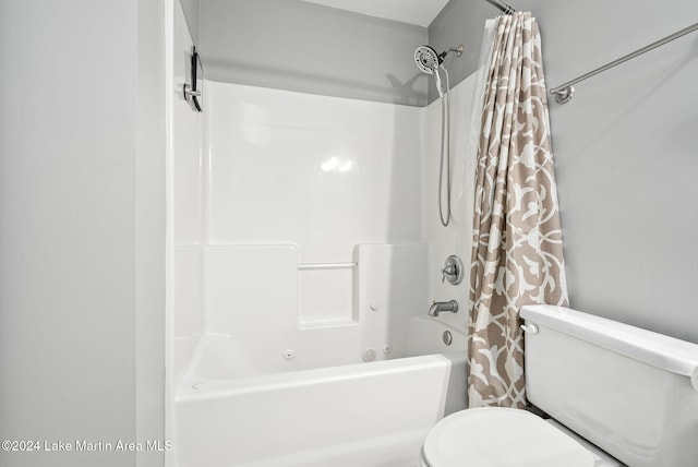 bathroom with shower / bath combo and toilet