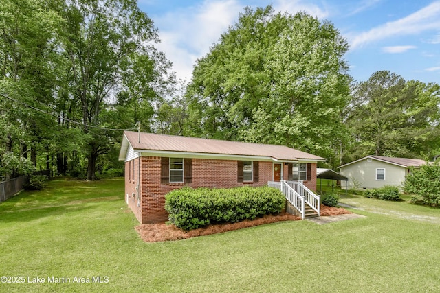ranch-style house with brick siding, a front lawn, and a carport