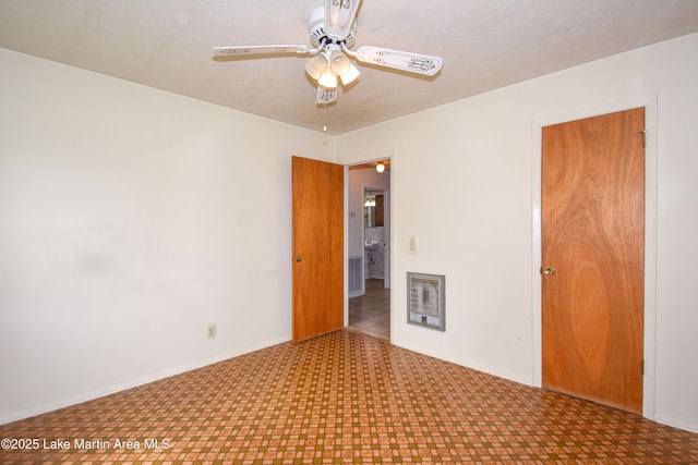 unfurnished room featuring tile patterned floors, baseboards, and a ceiling fan