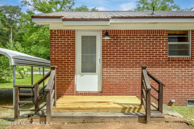 view of exterior entry with brick siding