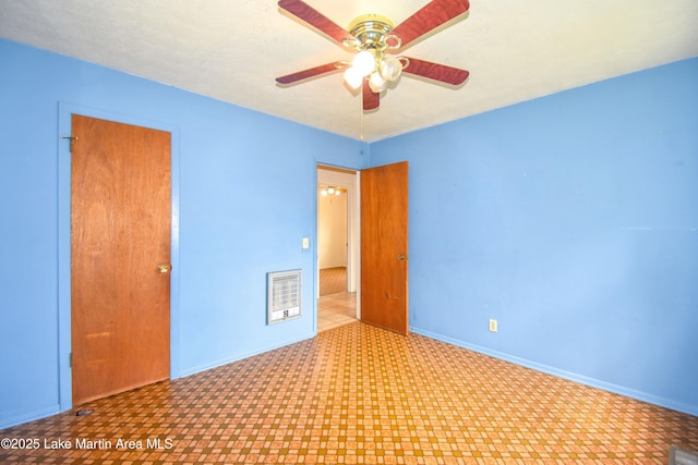 unfurnished room featuring tile patterned floors, baseboards, and ceiling fan
