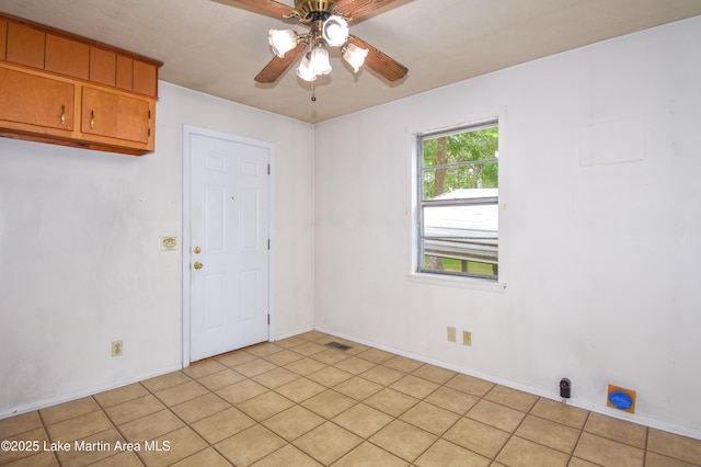 spare room with visible vents, baseboards, and ceiling fan