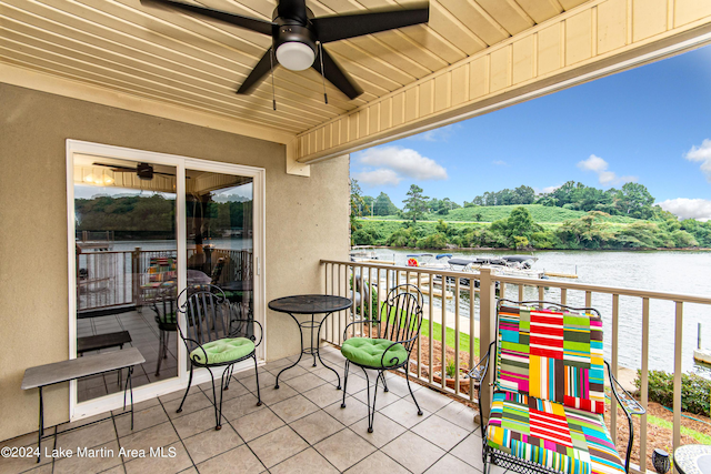 balcony with a water view and ceiling fan