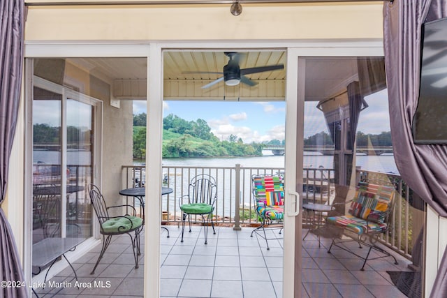 sunroom featuring a wealth of natural light, a water view, and ceiling fan