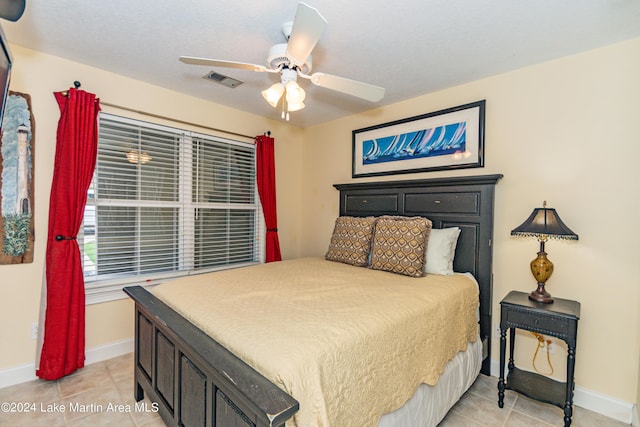 tiled bedroom featuring ceiling fan