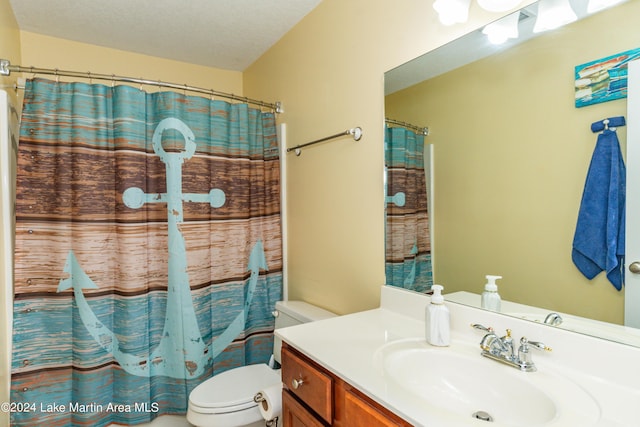 bathroom featuring a textured ceiling, vanity, toilet, and curtained shower