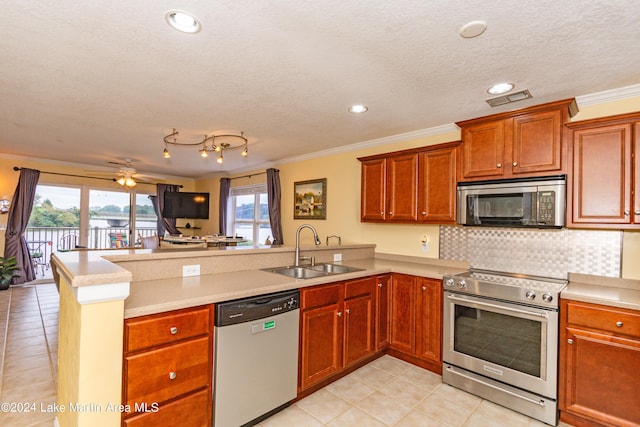 kitchen with kitchen peninsula, stainless steel appliances, ceiling fan, crown molding, and sink