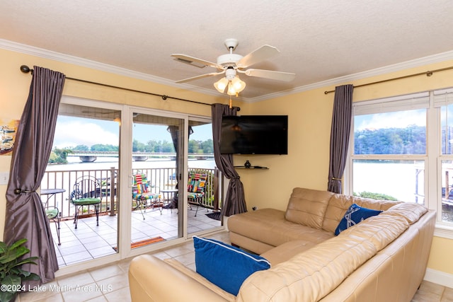 tiled living room with ceiling fan, a healthy amount of sunlight, and crown molding