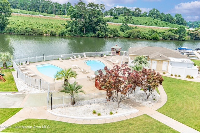 view of pool with a patio area and a water view