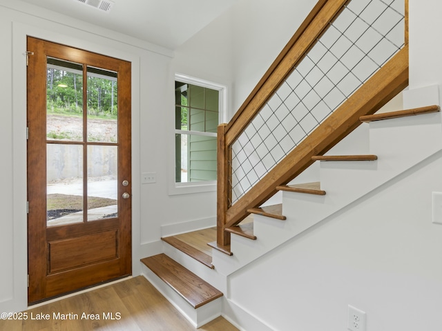 foyer with stairs and wood finished floors